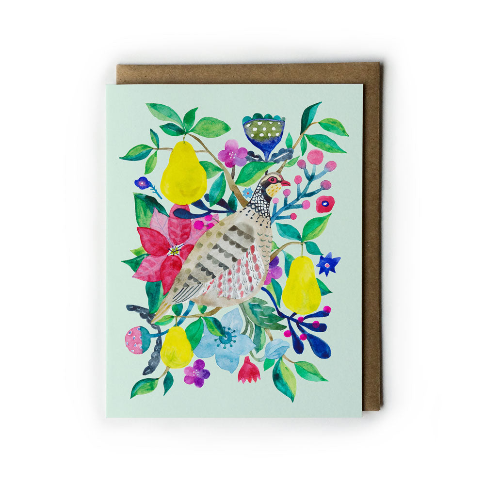 Colorful watercolor greeting card featuring a partridge surrounded by vibrant pears, flowers, and foliage on mint green background, with kraft envelope