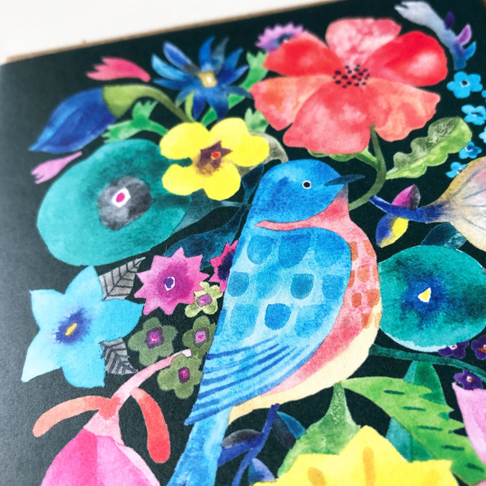 Vibrant watercolor greeting card featuring a blue bird surrounded by colorful flowers, including a large red bloom, yellow petals, and various shades of blue and green foliage, set against a dark background
