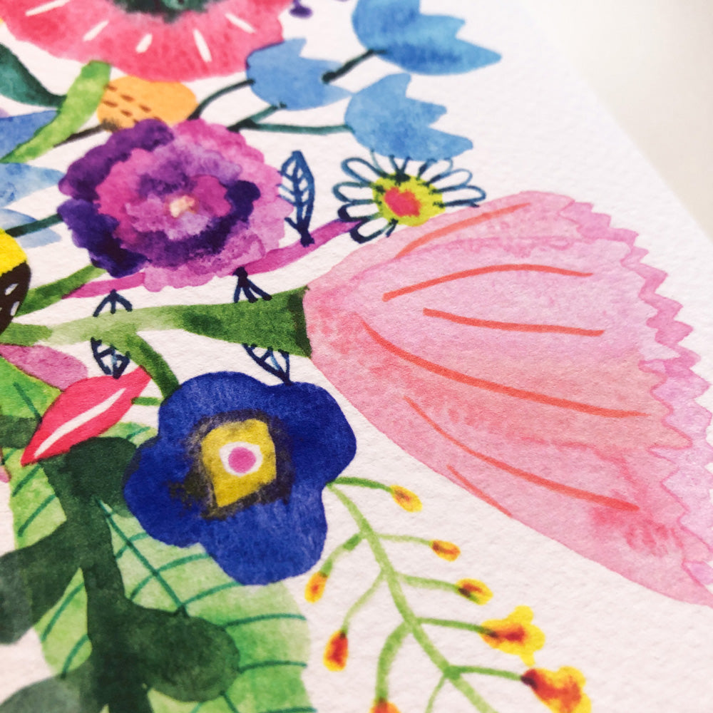 Vibrant watercolor floral print featuring colorful blooms including pink, purple, and blue flowers with green leaves on white paper, showcasing delicate brushstrokes and intricate details of a giclee art print