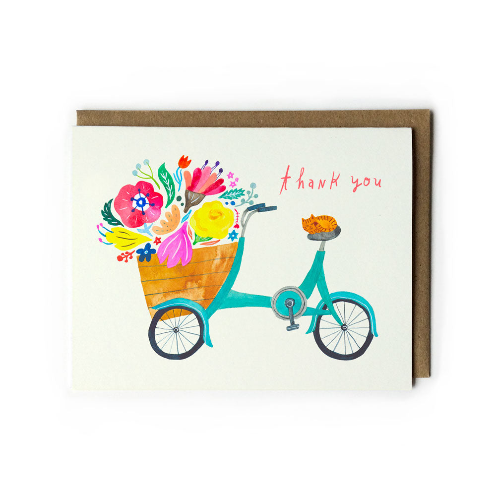Colorful thank you card featuring a teal bicycle with a basket full of vibrant flowers and a ginger cat on the seat, accompanied by a kraft paper envelope