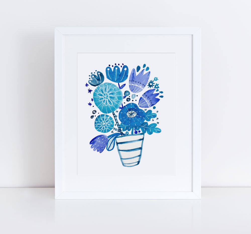 Watercolor illustration of a vibrant blue floral bouquet in a striped vase, featuring various flower shapes and sizes, framed in white against a neutral background