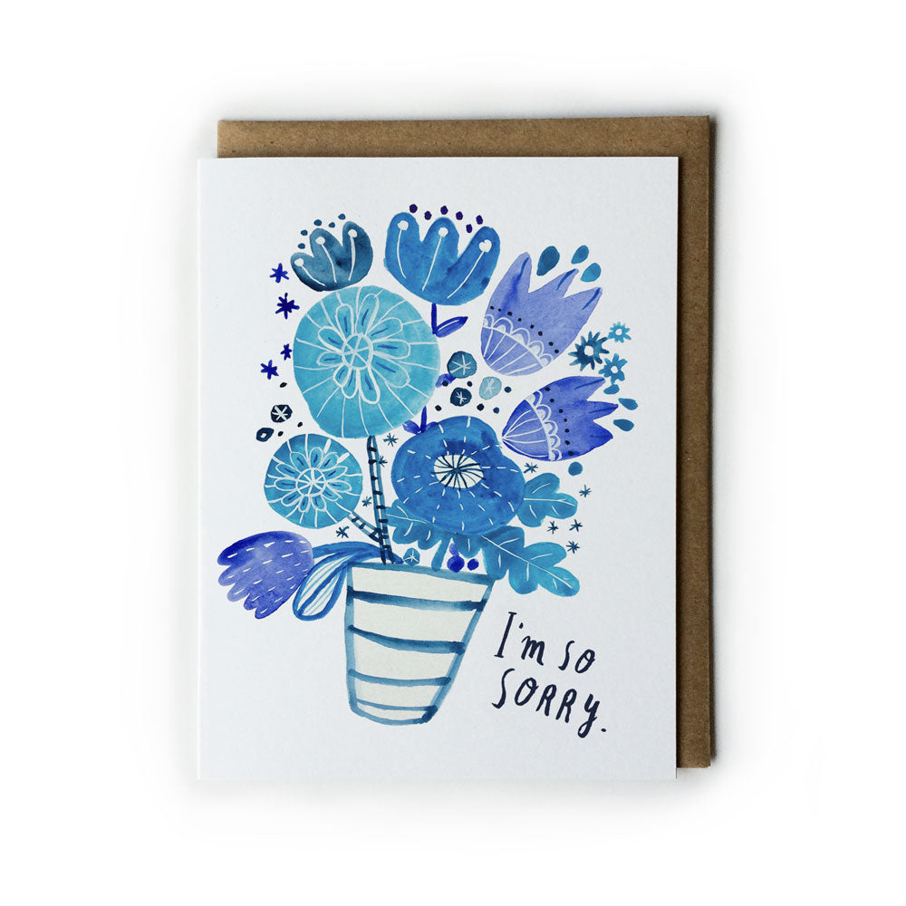 Blue floral sympathy card featuring watercolor bouquet in striped vase with "I'm so sorry" message, alongside brown kraft envelope
