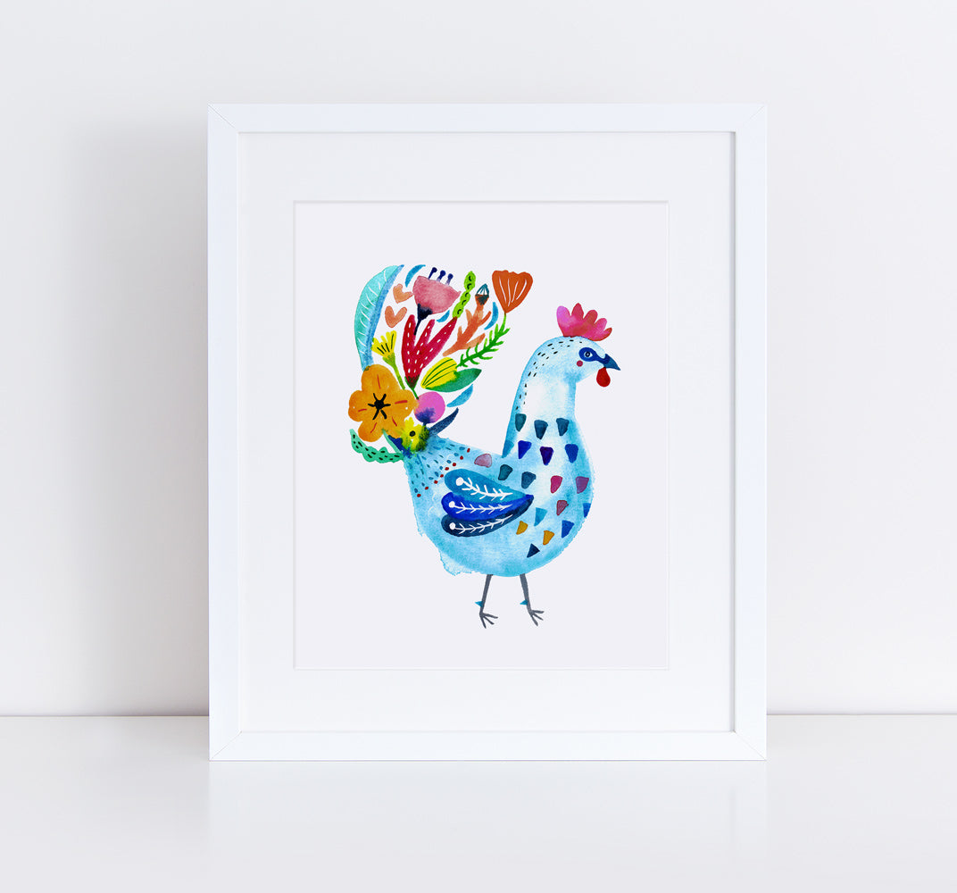 Colorful watercolor rooster art print featuring a blue chicken adorned with vibrant floral patterns, framed in white against a light background