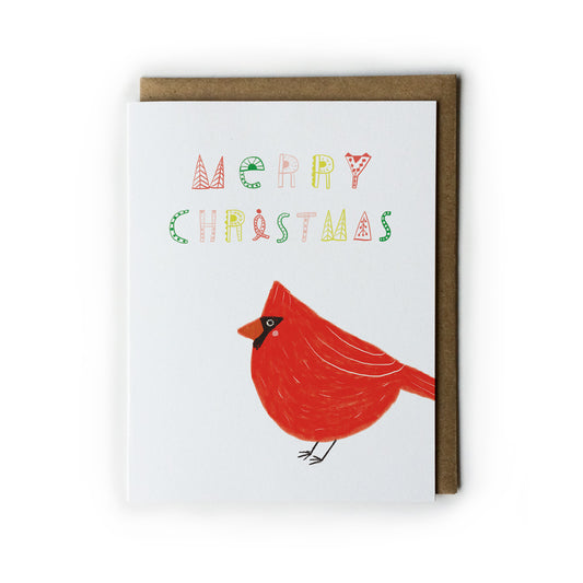Festive Christmas card featuring a bright red cardinal bird illustration and colorful hand-drawn Merry Christmas text, accompanied by a kraft paper envelope