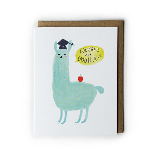 Graduation card featuring a cute mint-green llama wearing a graduation cap, with a speech bubble saying "Congrats and Good Luck!" and a small red apple, accompanied by a kraft envelope