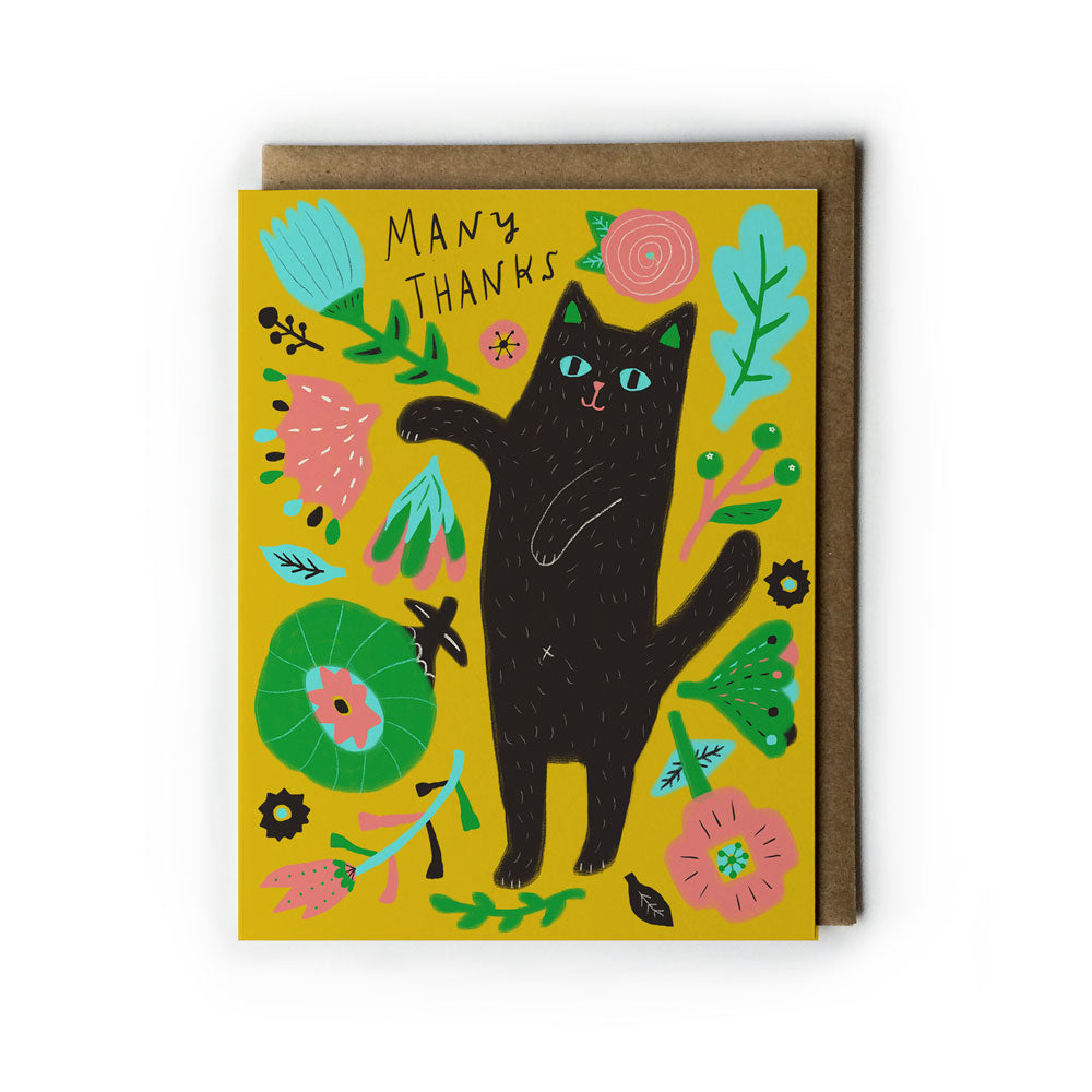 Colorful greeting card with playful black cat surrounded by vibrant flowers and leaves on yellow background, text reads "Many Thanks", paired with kraft paper envelope