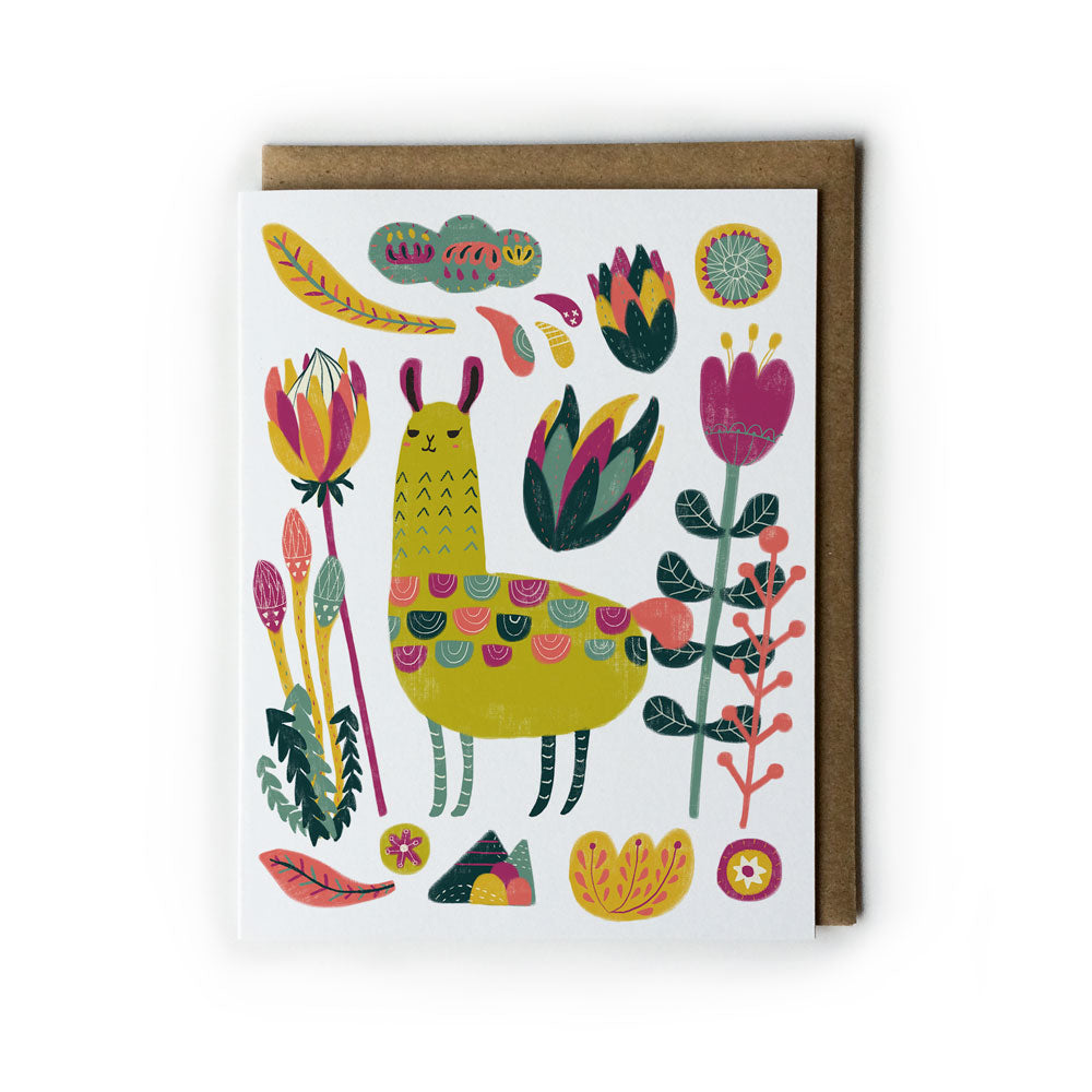 Colorful greeting card featuring whimsical illustration of llama surrounded by vibrant botanical elements, including flowers, leaves, and abstract shapes, on white background with kraft paper envelope