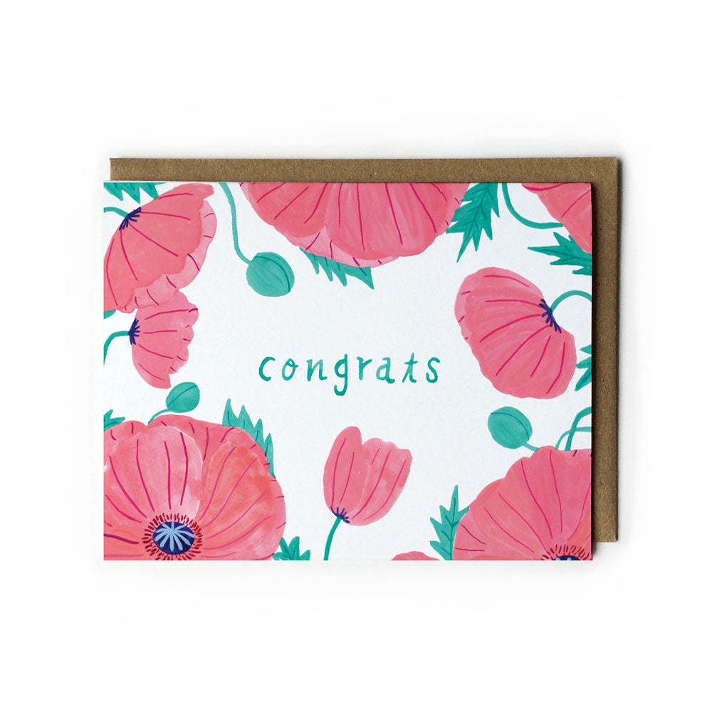 Pink watercolor poppies surround teal "congrats" text on a white greeting card with matching kraft envelope, perfect for summer weddings and congratulatory occasions