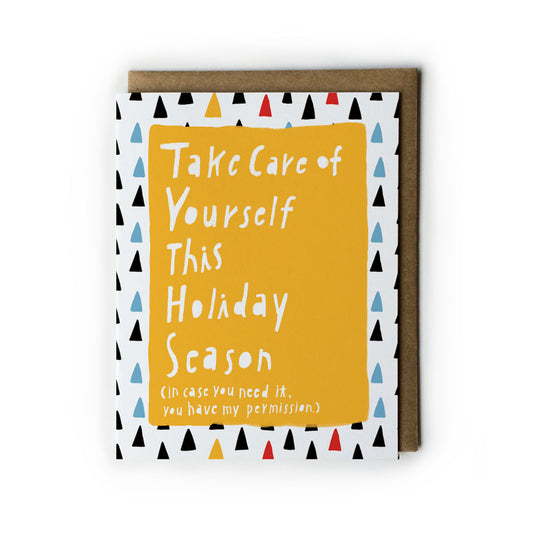 Holiday self-care card with yellow background and white text saying "Take Care of Yourself This Holiday Season", surrounded by colorful triangles pattern, with kraft paper envelope