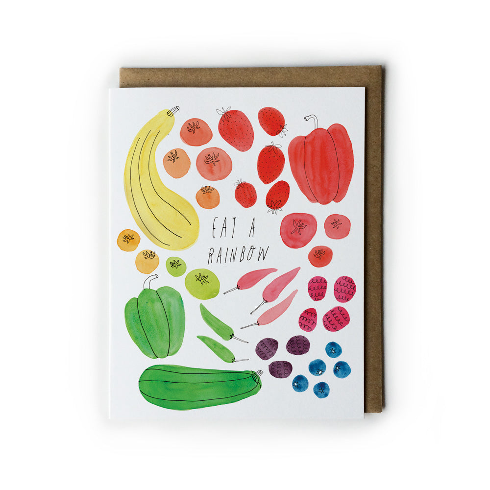 Colorful watercolor illustration of various fruits and vegetables arranged in a rainbow pattern on a greeting card, with the text "Eat a Rainbow" in the center, accompanied by a kraft paper envelope