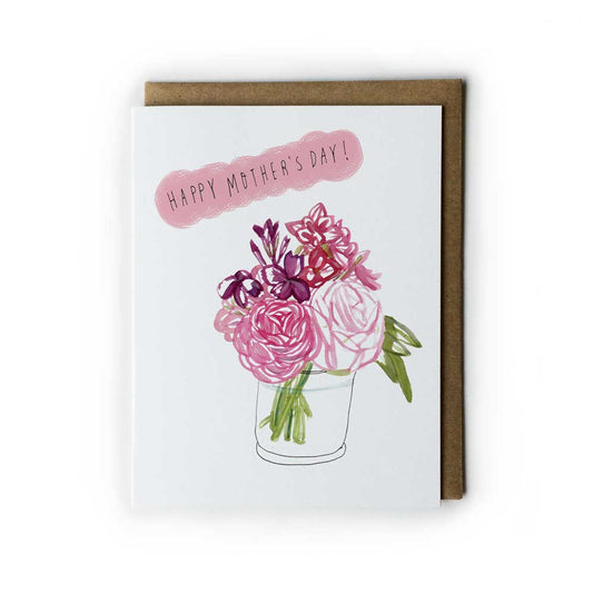 Watercolor Mother's Day card featuring pink and purple floral bouquet in a glass vase, with "Happy Mother's Day!" message on pink cloud-like shape, accompanied by kraft envelope