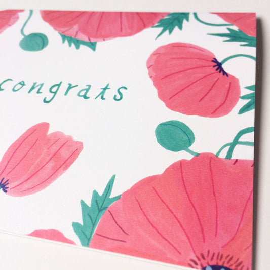 Watercolor greeting card featuring pink oriental poppies and green leaves on white background with handwritten 'Congrats' text, perfect for summer weddings or congratulatory occasions