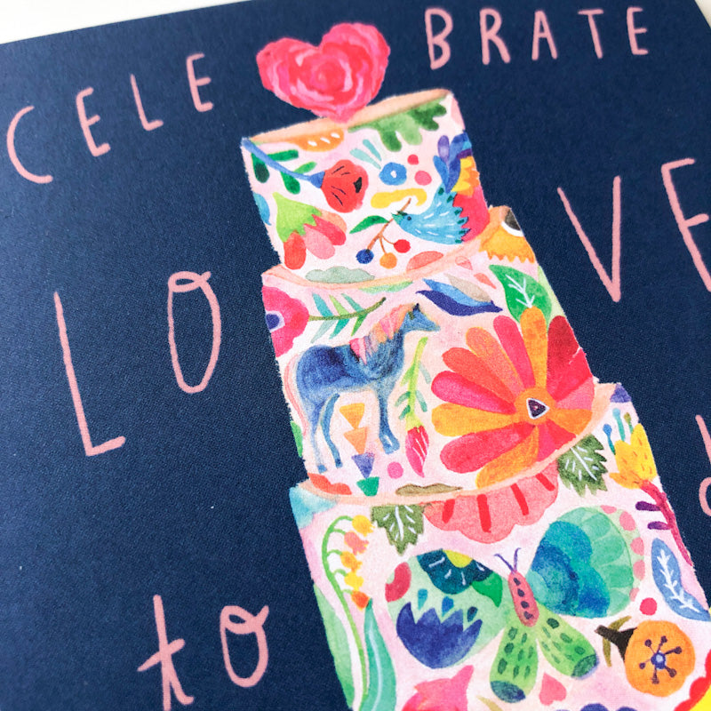 Colorful floral wedding cake illustration on navy background with text "Celebrate Love" in pink, featuring vibrant flowers, leaves, and a heart topper