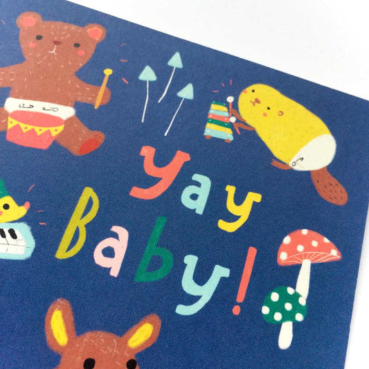 Colorful baby animal greeting card featuring cute woodland creatures playing instruments, with "Yay baby!" text, perfect for baby showers or new parent congratulations