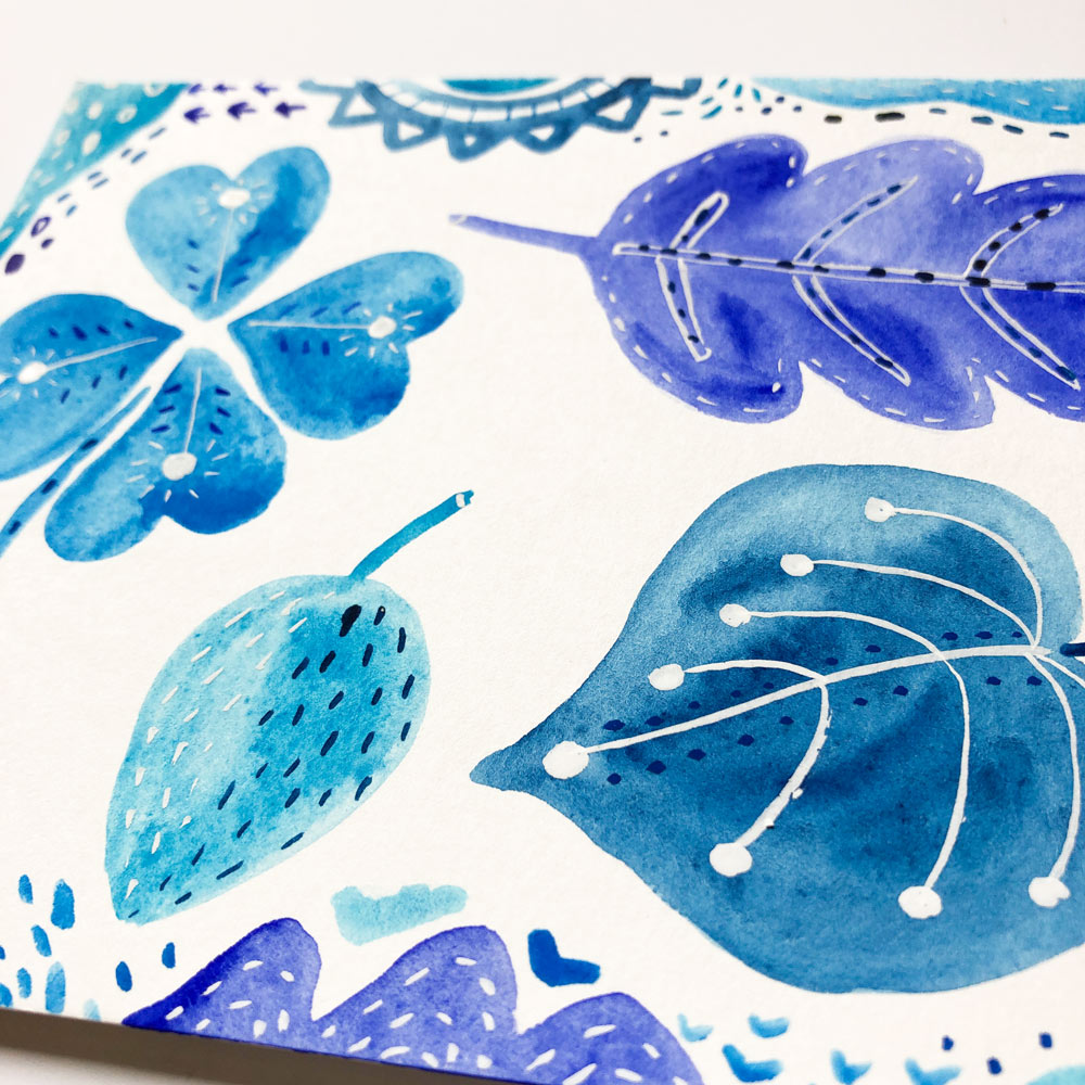Original watercolor painting featuring blue and purple stylized leaves and floral elements on white paper, showcasing a delicate and whimsical botanical design with intricate details and varying shades of blue