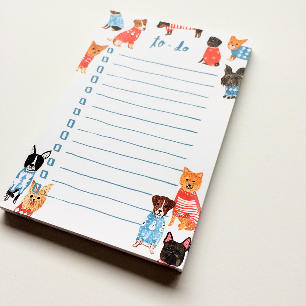 Whimsical to-do list notepad featuring watercolor illustrations of adorable small dogs in colorful sweaters, surrounding lined writing space for tasks, perfect for dog lovers and organizing with a cute touch