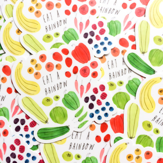 Colorful illustration of various fruits and vegetables forming a rainbow pattern with repeated text "Eat a Rainbow" scattered throughout, showcasing a diverse array of healthy foods in vibrant colors