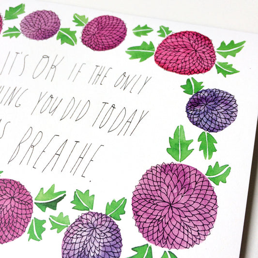 Watercolor greeting card featuring pink and purple chrysanthemum flowers with green leaves, surrounding handwritten text "It's OK if the only thing you did today was breathe