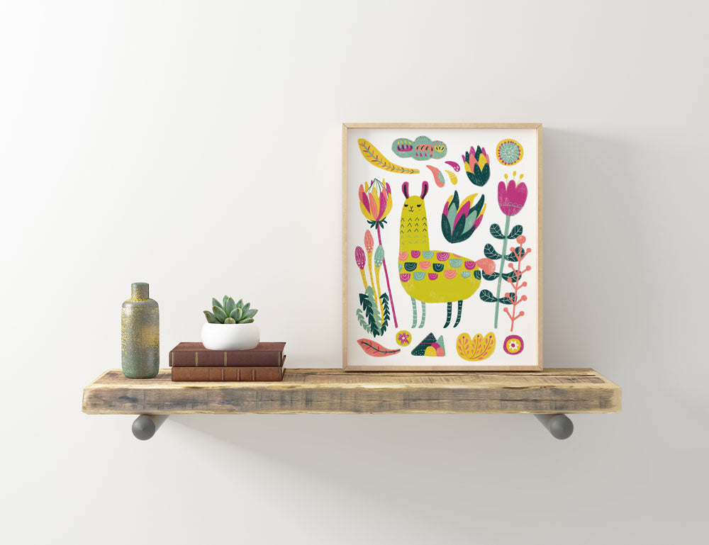 Colorful botanical llama art print displayed on rustic wooden shelf with books, plant, and vase, showcasing whimsical floral motifs and vibrant design