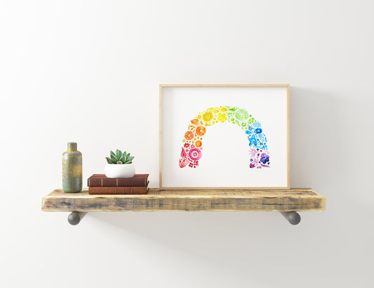 Colorful rainbow flower arch watercolor print displayed on rustic wooden shelf with books, plant, and vase, showcasing vibrant home decor art against white wall