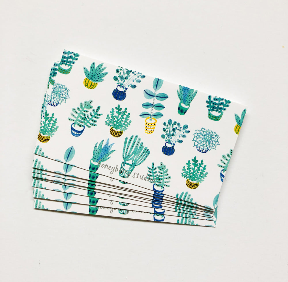 Set of small white cards with colorful succulent plant illustrations, stacked neatly on a light background. The cards feature various potted cacti and succulents in blue, green, and yellow tones, perfect for mini greetings or gift tags.