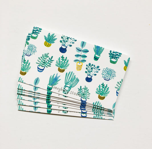 Set of small white cards with colorful succulent plant illustrations, stacked neatly on a light background. The cards feature various potted cacti and succulents in blue, green, and yellow tones, perfect for mini greetings or gift tags.