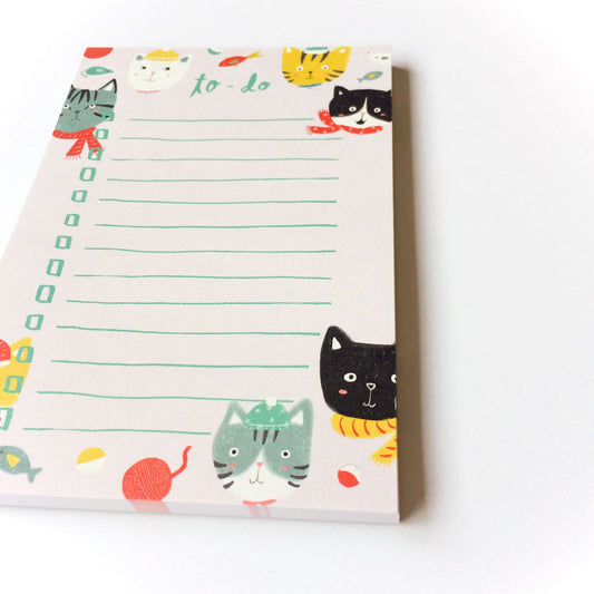 Winter kitties to-do list notepad with colorful cat illustrations wearing scarves, lined writing space, and festive holiday decorations, perfect for organizing tasks and gift-giving