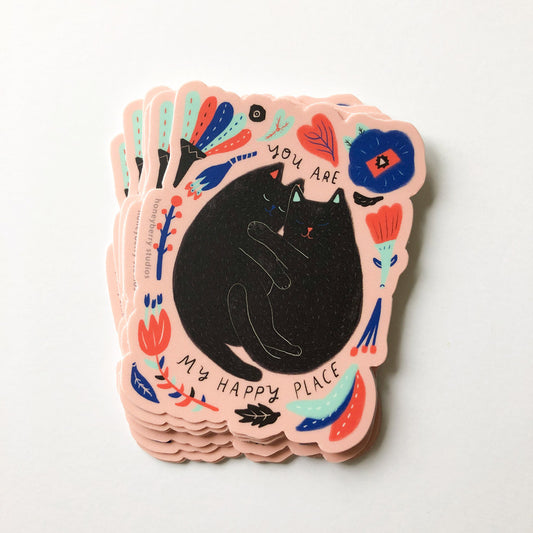 Colorful vinyl sticker featuring a black cat surrounded by floral designs and text "You are my happy place" in playful typography, perfect for cat lovers and as a cheerful decoration