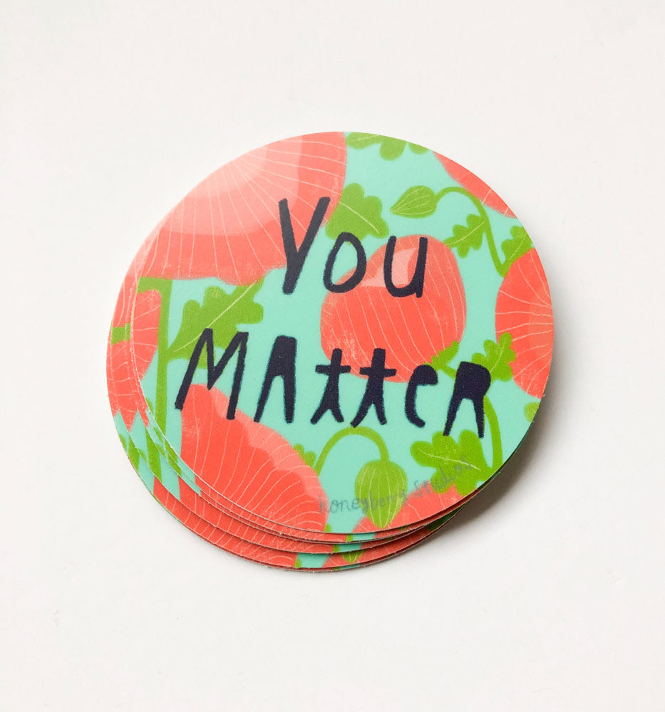 Colorful round vinyl sticker with "You Matter" text, featuring pink floral patterns and green leaves on a light background, perfect for inspiring confidence and self-worth