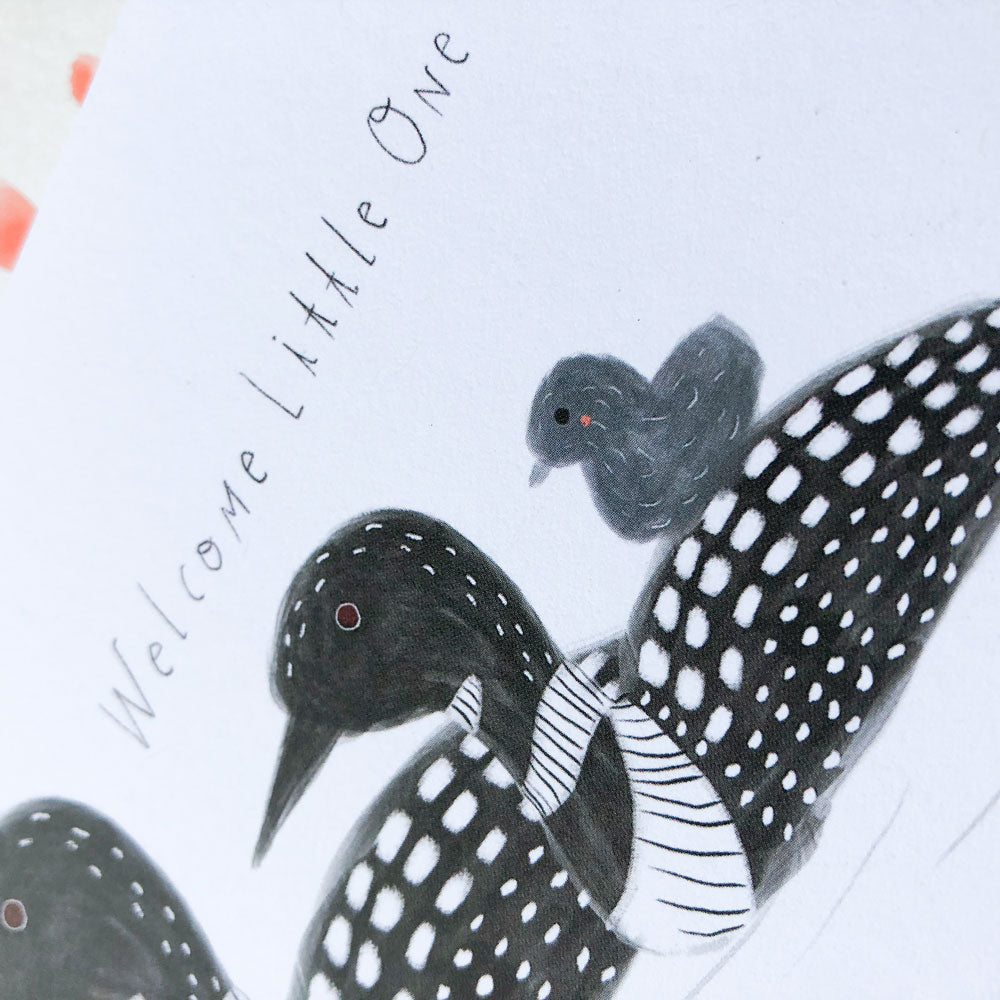Hand-drawn illustration of adult and baby loons on a greeting card, featuring black and white spotted patterns on the adult loon and a small gray chick, with "Welcome Little One" text
