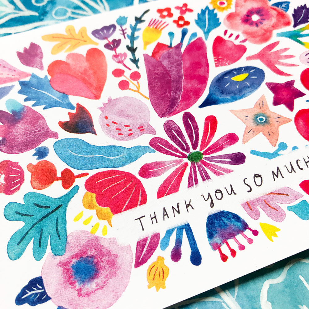 Colorful watercolor floral design greeting card with "Thank you so much" text, featuring vibrant pink, red, blue, and purple flowers, hearts, and leaves on white background