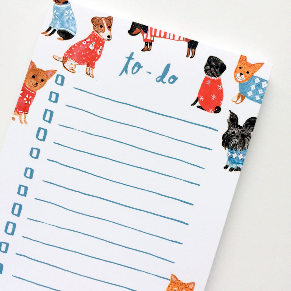 Colorful to-do list notepad featuring whimsical watercolor illustrations of small dogs wearing festive sweaters, surrounding blank lines for tasks, perfect for dog lovers and organizing daily activities