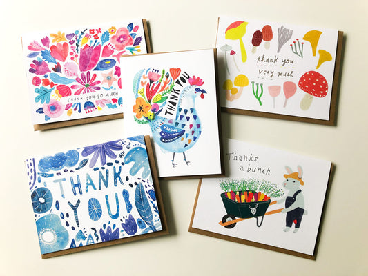 Colorful thank you card bundle featuring five unique designs: floral pattern, blue rooster, mushroom-themed, blue floral, and bunny with carrot wheelbarrow. Each card showcases vibrant watercolor illustrations on white backgrounds, perfect for expressing gratitude in various styles.