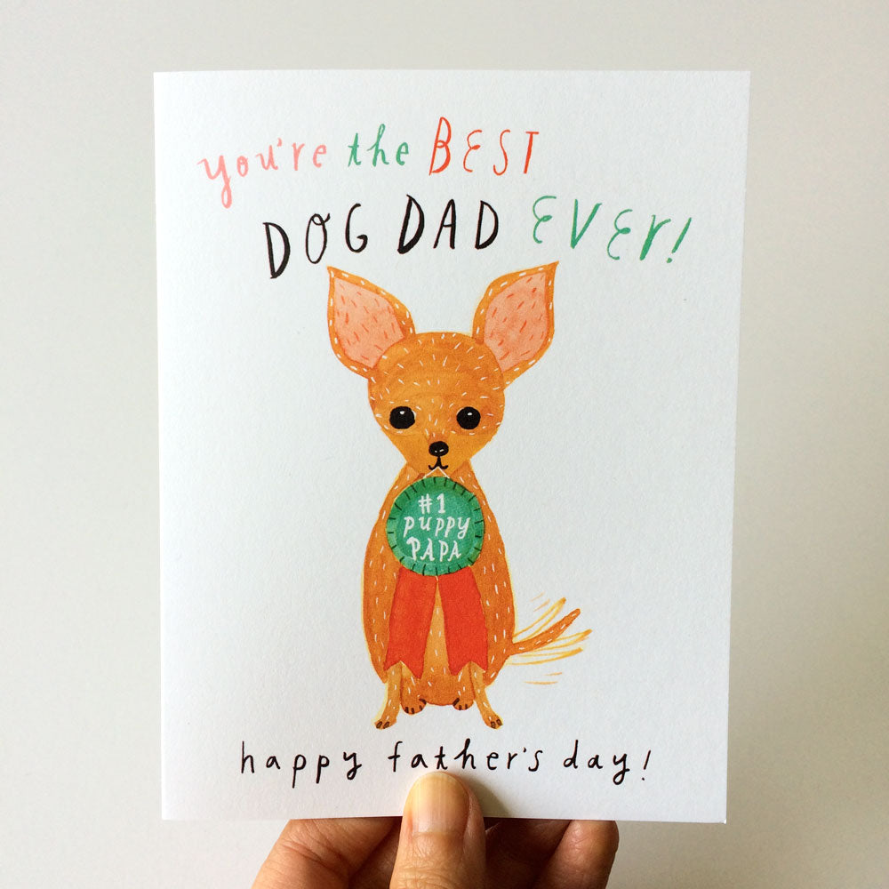 Watercolor Father's Day card featuring a cute chihuahua with large ears wearing a "1 Puppy Papa" badge, text reads "You're the BEST DOG DAD EVER!" and "happy father's day!" Hand holding the card visible at bottom.
