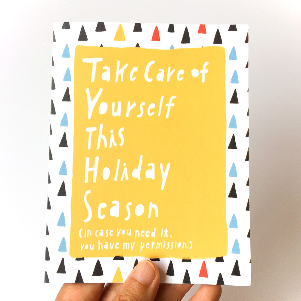 Holiday self-care card with yellow background and white text reading "Take Care of Yourself This Holiday Season" on a colorful triangle pattern, held by a hand