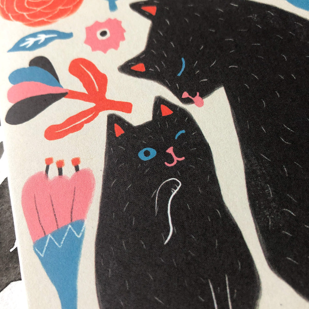 Cute greeting card design featuring two black cats with colorful floral elements, perfect for congratulating new parents on their growing family