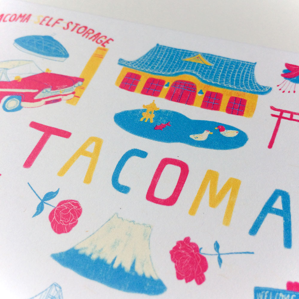 Colorful illustrated greeting card featuring iconic Tacoma landmarks and symbols, including Elf Storage sign, pagoda-style building, mountain, and stylized "TACOMA" text in vibrant hues against a white background.