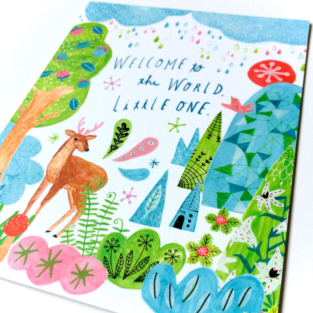Colorful baby greeting card featuring whimsical forest scene with deer, trees, flowers, and "Welcome to the World Little One" hand-lettered text. Vibrant watercolor-style illustration on white background.