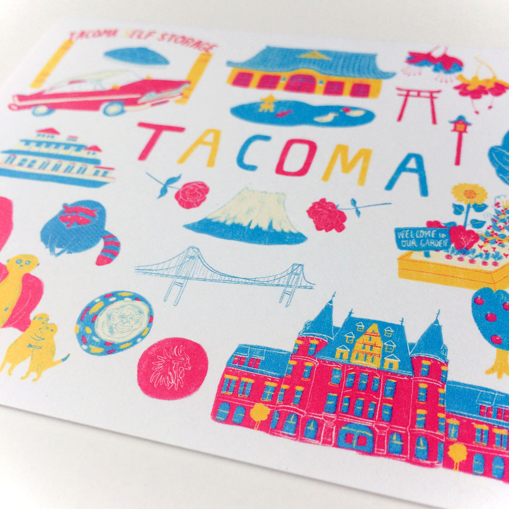 Colorful illustrated greeting card featuring iconic Tacoma landmarks and symbols, including the Tacoma Dome, Narrows Bridge, Stadium High School, and various attractions, arranged around the word "TACOMA" in vibrant colors on a white background.