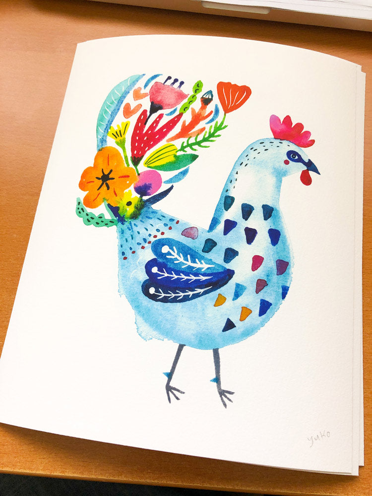 Colorful watercolor giclee art print of a whimsical blue rooster with vibrant floral tail feathers, showcasing folk art style on textured paper