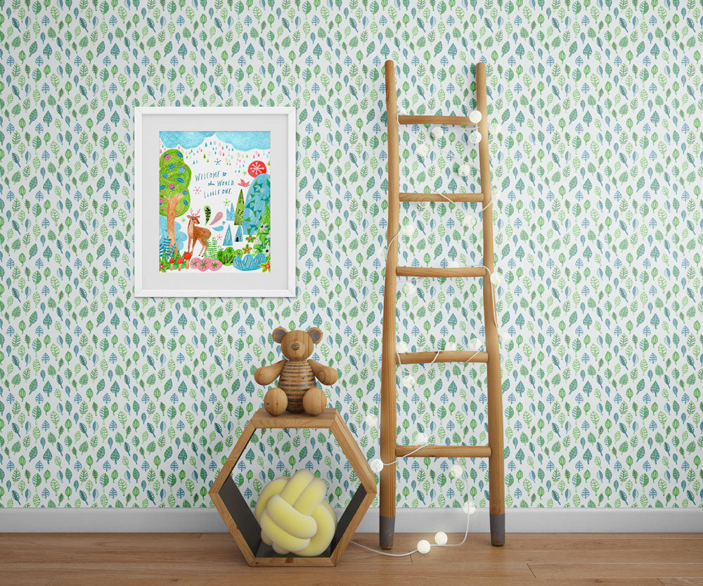 Framed woodland nursery art print on leaf-patterned wallpaper, wooden ladder, teddy bear on hexagonal shelf, and yellow cushion in cozy room setting