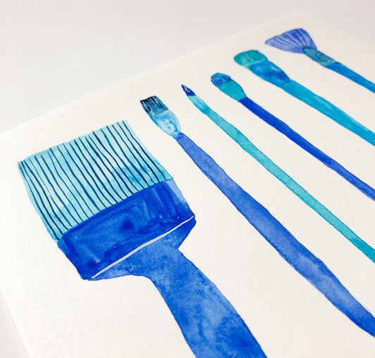 Watercolor painting of five blue paint brushes arranged diagonally on white paper, showcasing various brush types including a wide flat brush and thin detail brushes