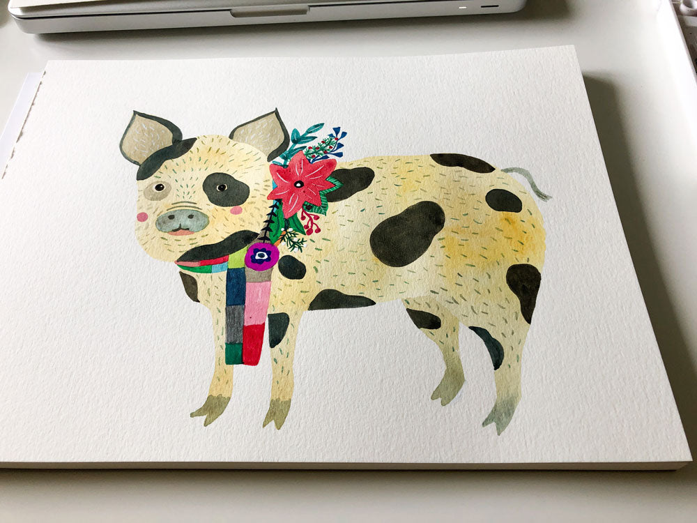 Watercolor illustration of a cheerful spotted pig wearing a colorful floral collar, standing on a white canvas. The pig has a smiling expression and vibrant holiday-themed decorations, perfect for a festive greeting card design.