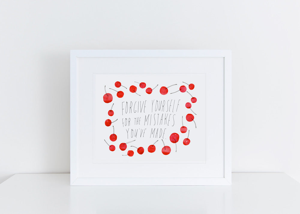 Minimalist art print with handwritten text "Forgive yourself for the mistakes you've made" surrounded by watercolor red cherries, framed in white, evoking a sense of peace and self-compassion.