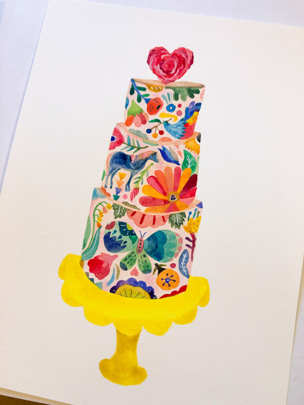 Colorful floral wedding cake illustration on greeting card, featuring vibrant flowers, leaves, and abstract designs on a three-tiered cake with a heart-shaped topper, set on a yellow cake stand