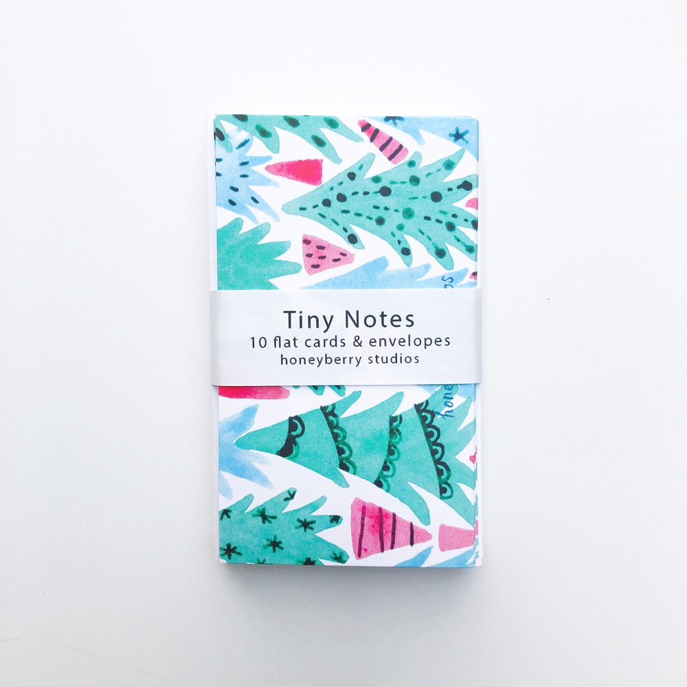 Colorful Christmas tree-themed tiny notes set with 10 flat cards and envelopes, featuring watercolor illustrations in turquoise, pink, and blue. White band labeled "Tiny Notes" wraps around the pack, perfect for mini greetings and gift tags.