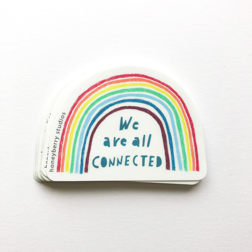 Colorful rainbow sticker with hand-lettered text "We are all connected" on white background. Vinyl design featuring vibrant arched stripes in red, orange, yellow, green, blue, and purple. Inspirational message emphasizes unity and interconnectedness.