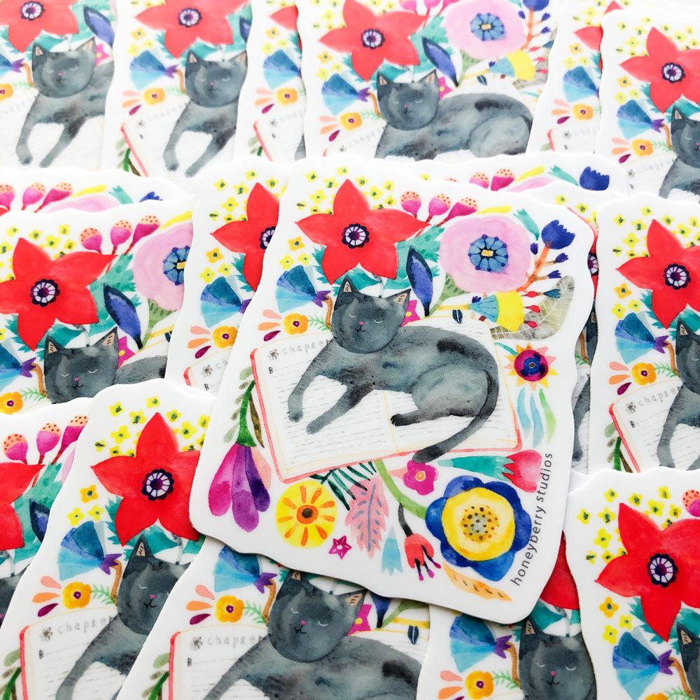 Watercolor stickers featuring grey cats napping among vibrant flowers. Multiple stickers displayed with colorful floral patterns and sleeping felines, showcasing a whimsical and artistic design for cat lovers.