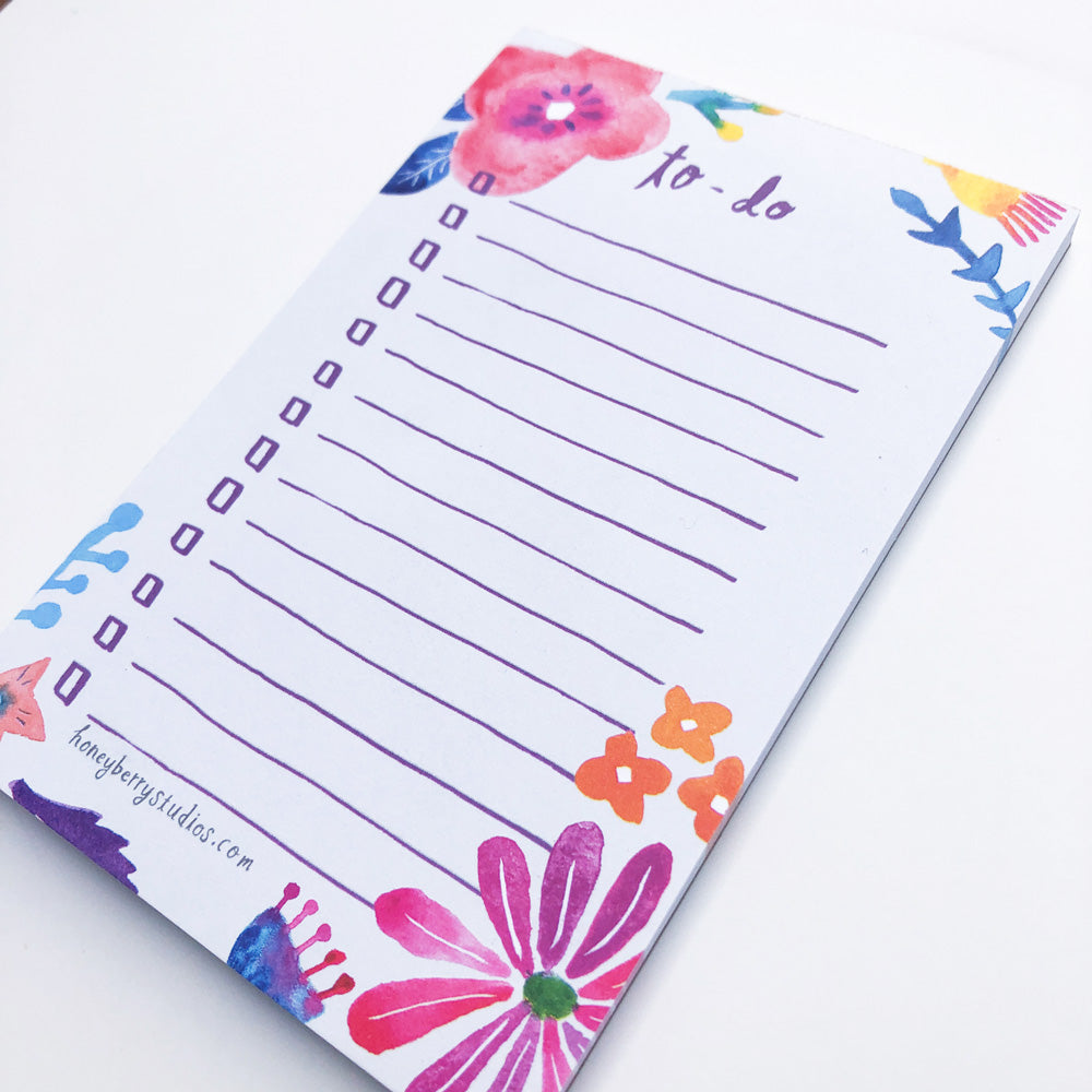 Colorful floral to-do list notepad with pink and red watercolor flowers, blue accents, and lined spaces for tasks. Measures 4x6 inches with 50 sheets, perfect for organizing daily activities or as a gift for nature lovers.