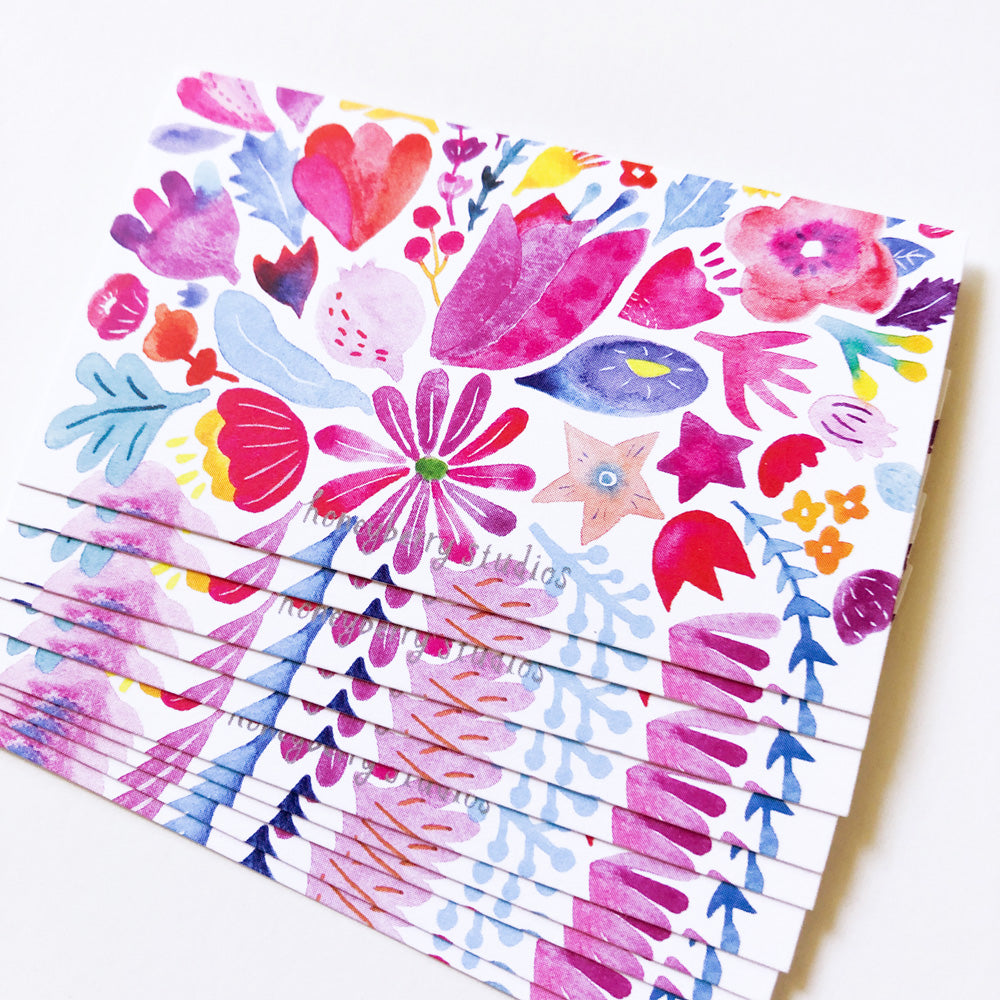 Colorful watercolor floral notecards featuring vibrant red, pink, and purple flowers with blue accents, stacked to show multiple cards in a set, perfect for mini greetings or gift tags